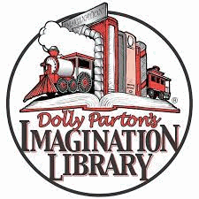 A row of books held up by train bookends, resting on an open book. The caption reads Dolly Parton's Imagination Library